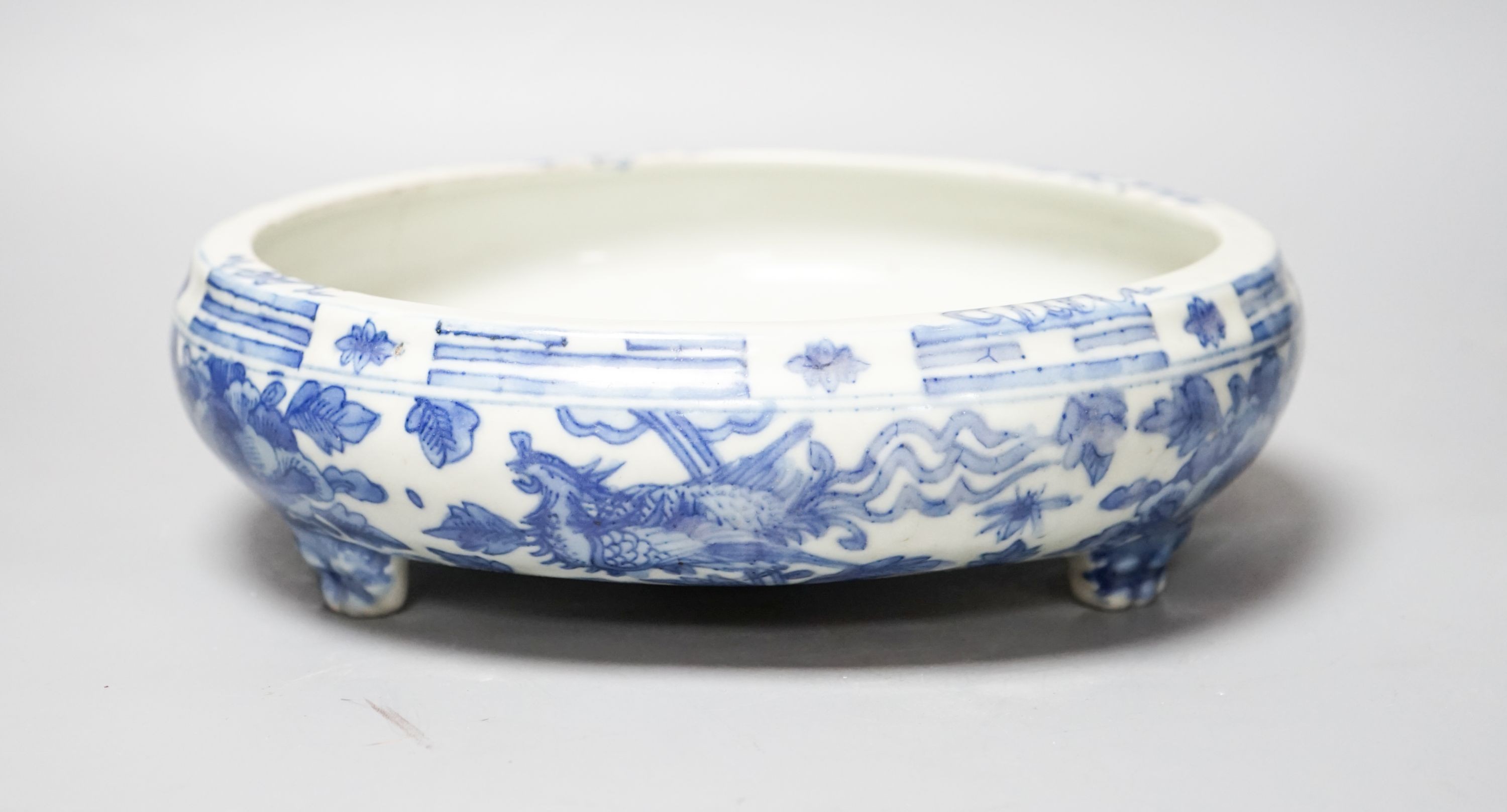 A 19th century Chinese circular blue and white censer, with phoenix and peony decoration, on three lion's paw feet 26cm
